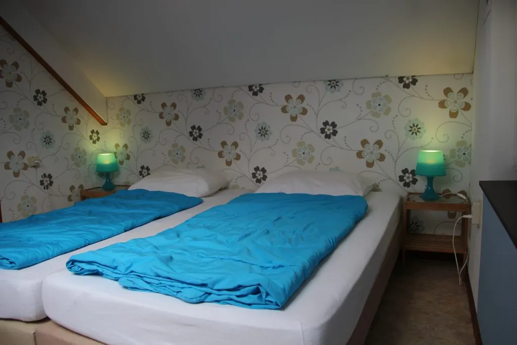 Een slaapkamer in De Wingerd